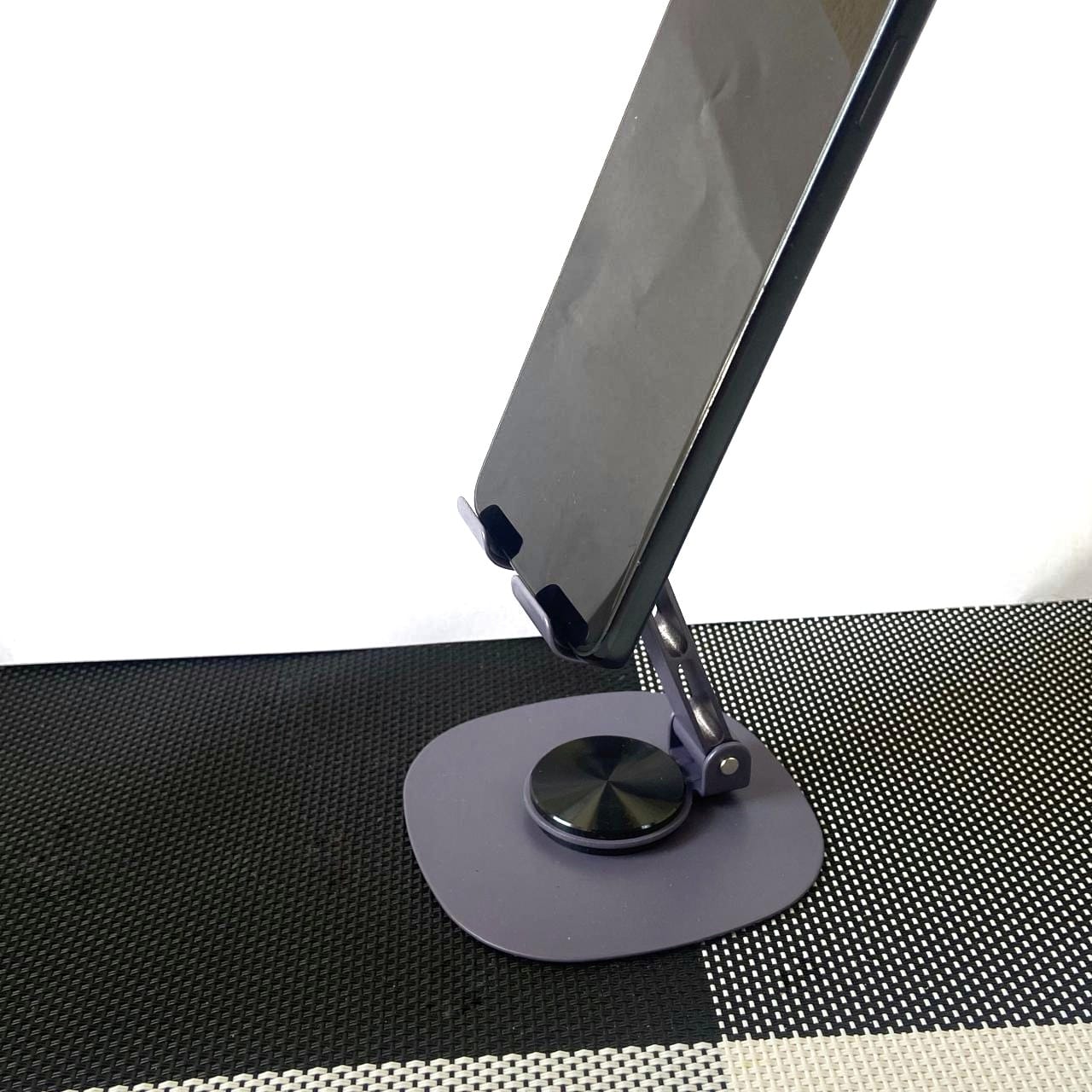 Phone stand on a textured surface with a white background