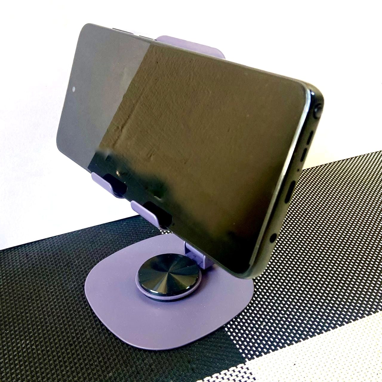 Smartphone on a stand with a white background