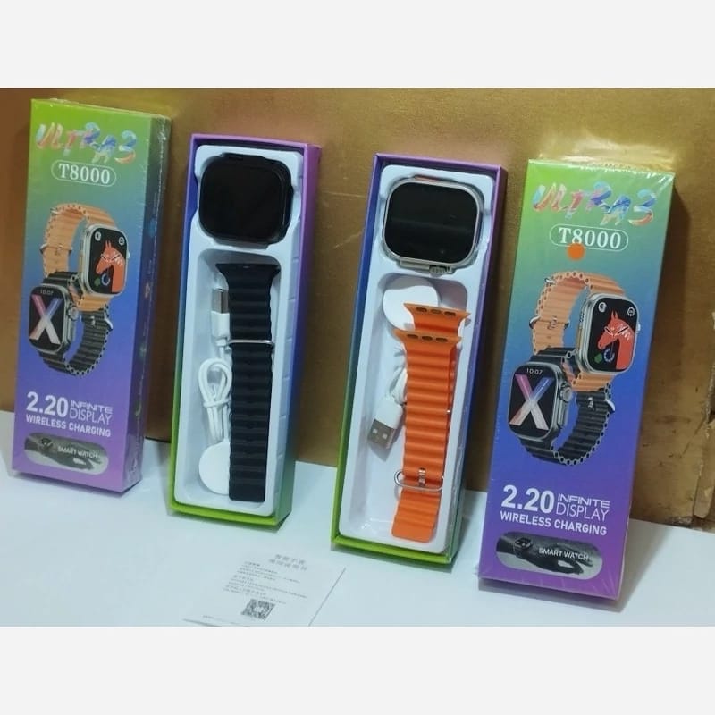 Two smartwatch boxes with different colored straps on a wooden surface.
