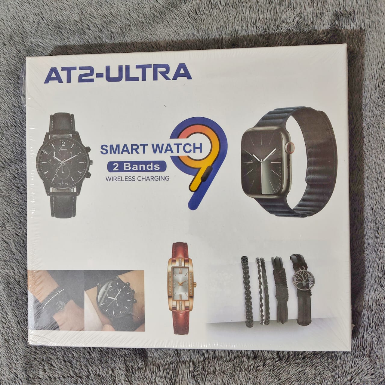 Box for AT2-Ultra smart watch with images of the watch and bands on a gray textured background