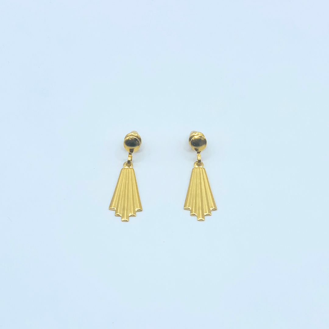 Gold earrings with a light blue background