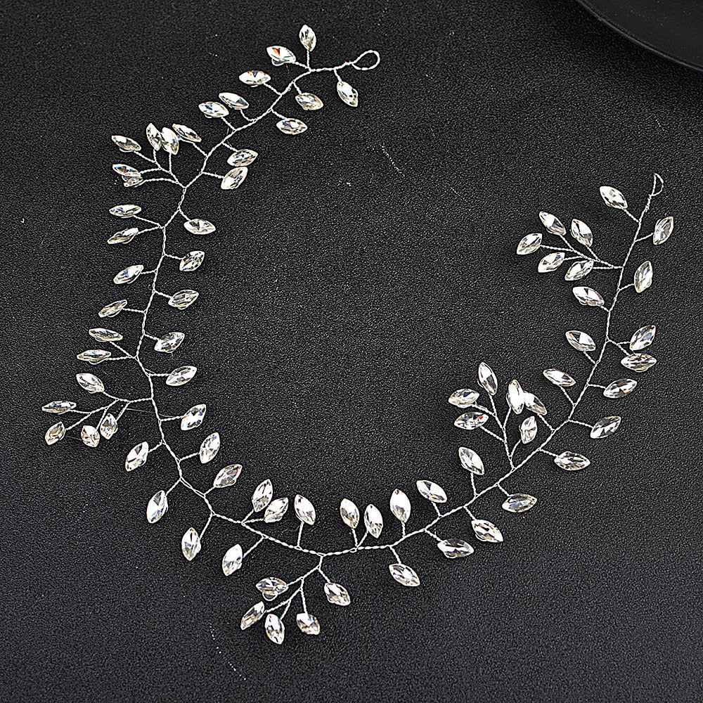 Silver leaf-shaped jewelry piece on a black background