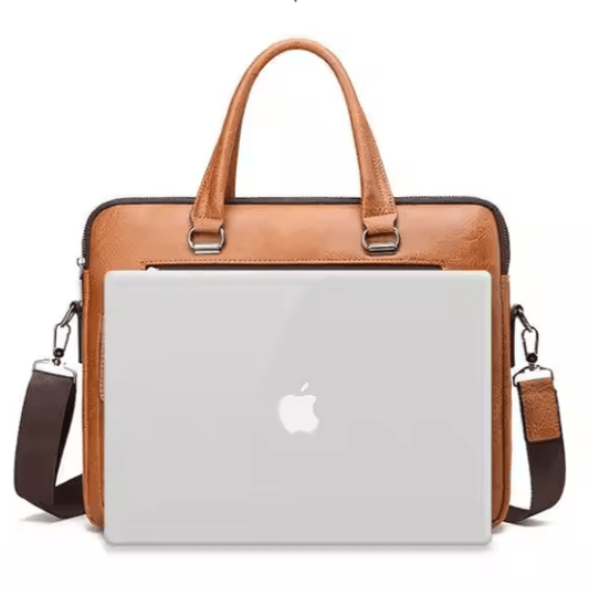 Brown leather laptop bag with a white Apple laptop inside on a white background