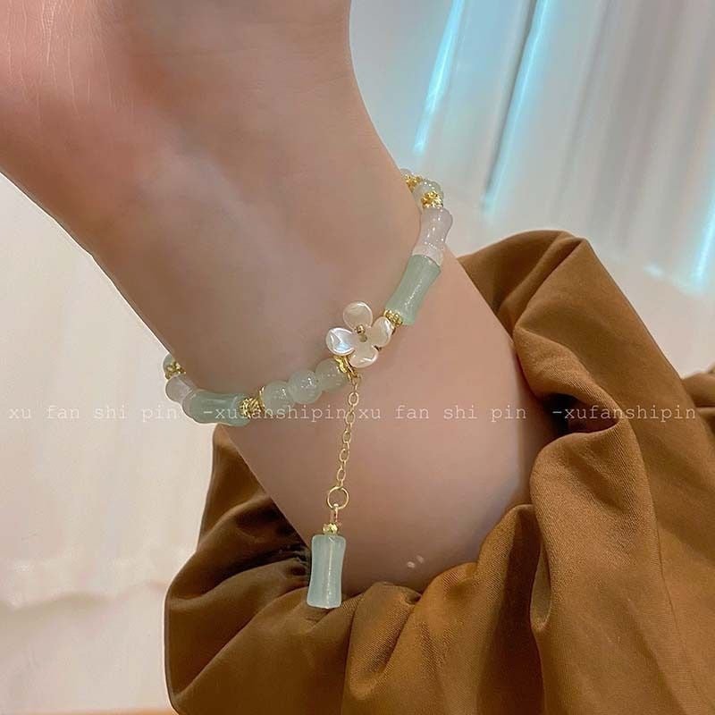 Beaded bracelet on a wrist with a neutral background