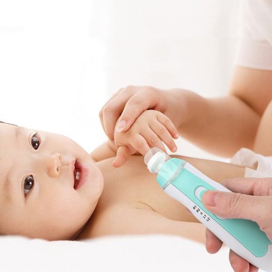 Baby lying down with a person using a green and white device on their arm.