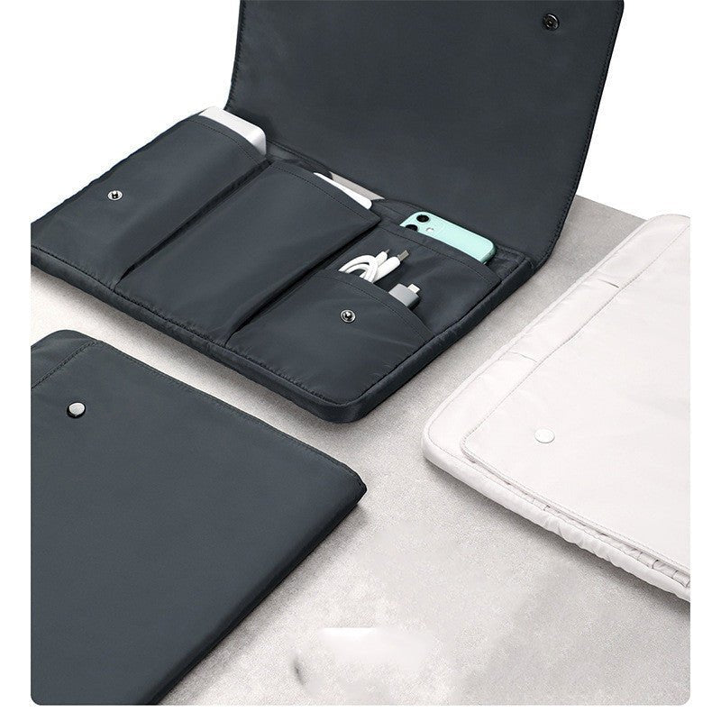 Black travel organizer with compartments on a light gray surface
