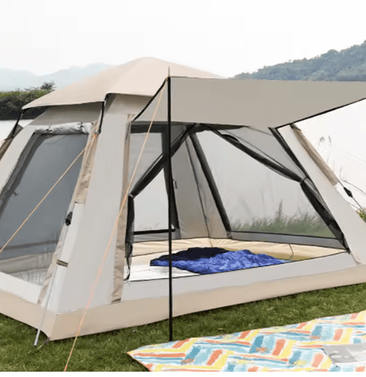 Camping tent with screen porch on grassy area with colorful blanket