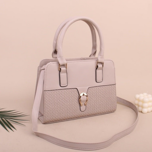 Light gray handbag with a strap on a beige background