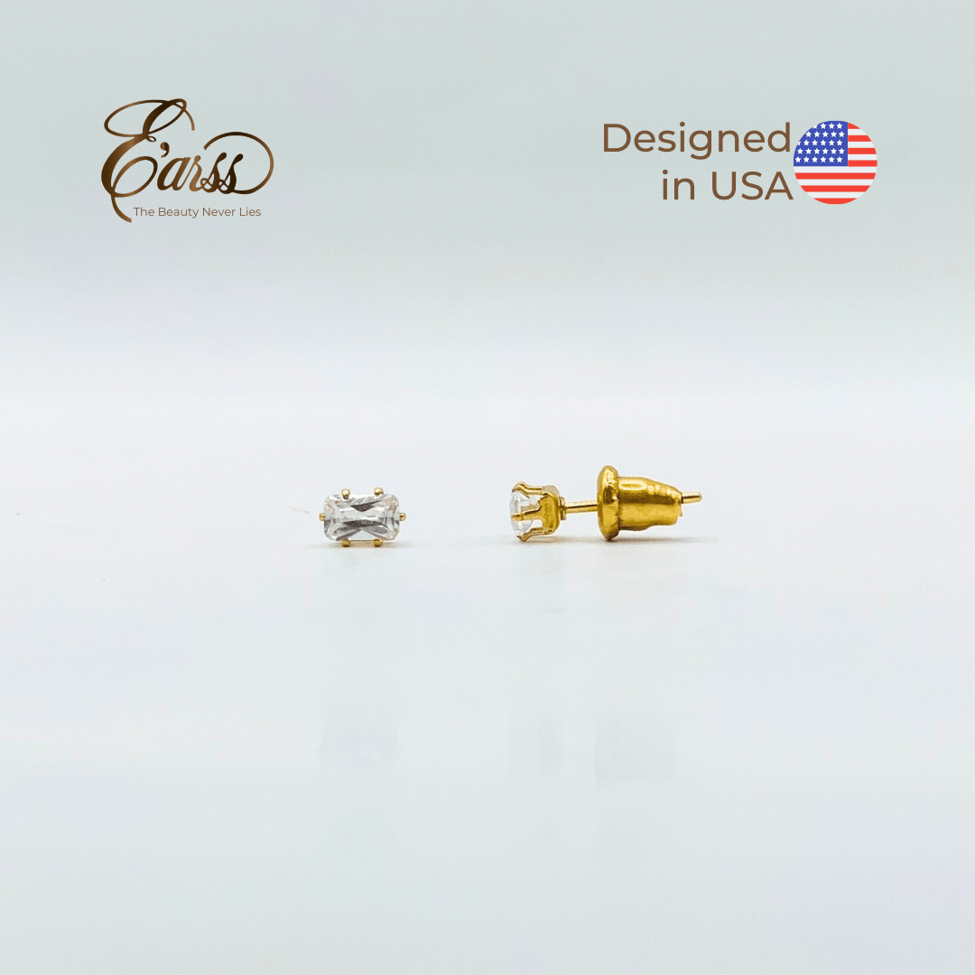 Gold stud earrings with clear gemstones on a light gray background, featuring 'Earss' brand and 'Designed in USA' text.