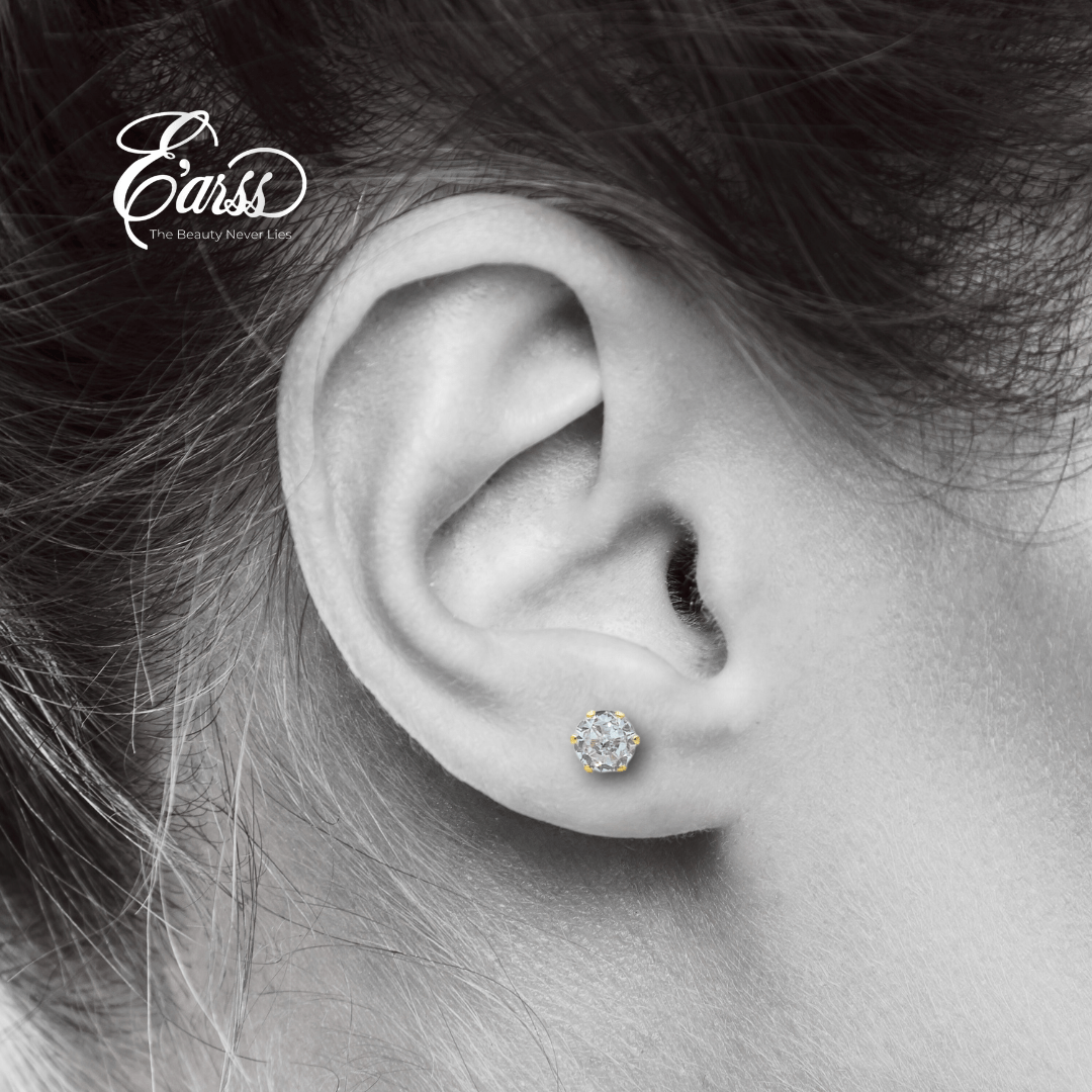 Close-up of an ear wearing a diamond stud earring with 'Earss' branding.