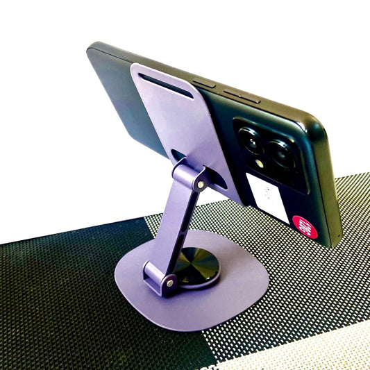 Phone stand holding a smartphone on a textured surface