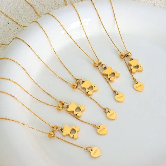 Gold necklaces with heart-shaped pendants on a white surface