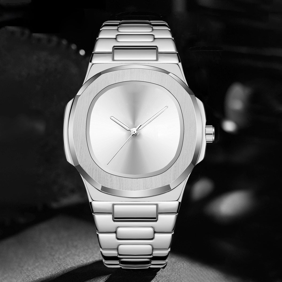 Silver wristwatch with a sleek design on a dark background