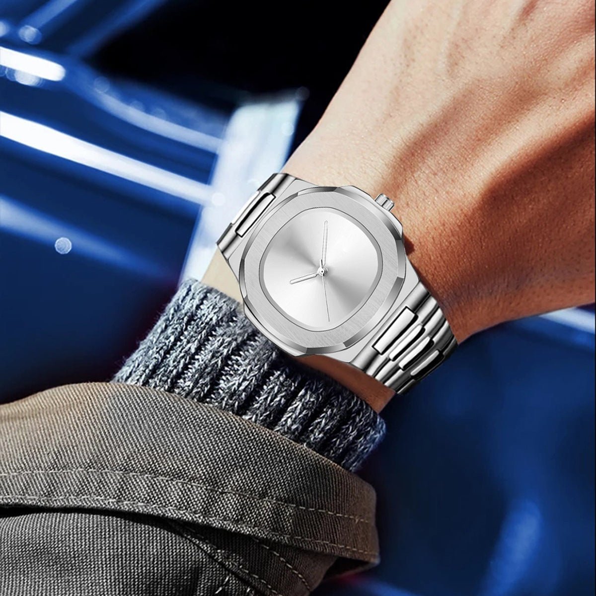 Silver watch on a wrist with a blurred background