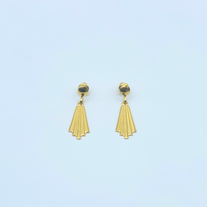 Gold earrings with a light blue background