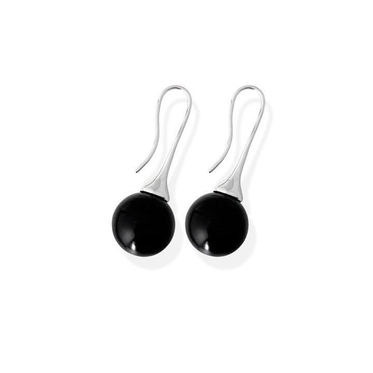 Pair of black spherical earrings on silver hooks against a white background