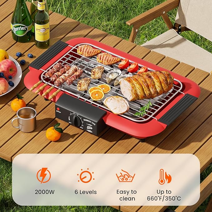 Portable grill on a wooden table with food and drinks, set outdoors.