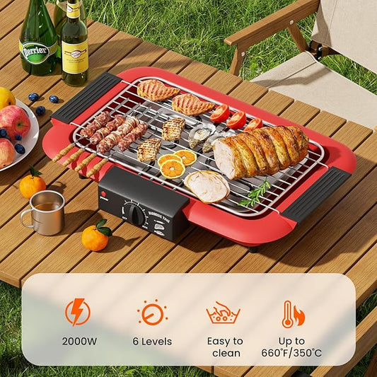 Portable grill on a wooden table with food and drinks, set outdoors.