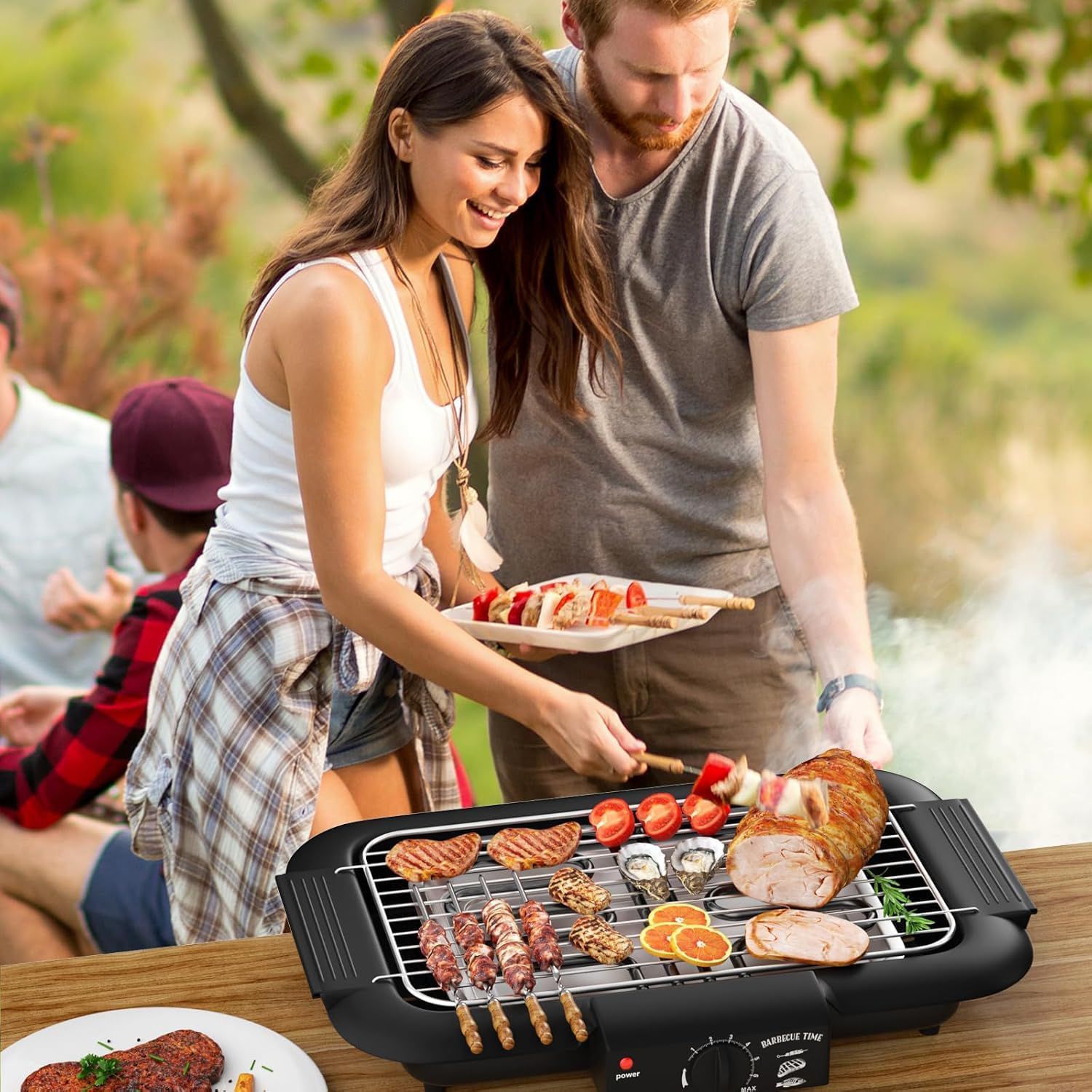 Couple grilling outdoors with a portable electric grill