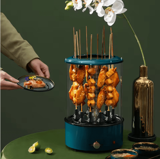 Blue skewer holder with grilled food on a green surface, with a person holding a plate of food.
