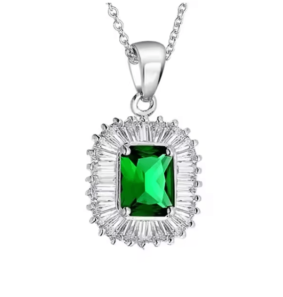 Silver necklace with a green gemstone pendant on a white background