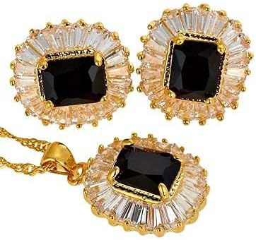Gold jewelry set with black gemstones on a white background