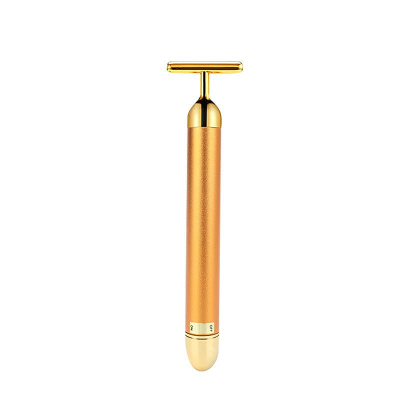Gold-toned handheld device on a white background