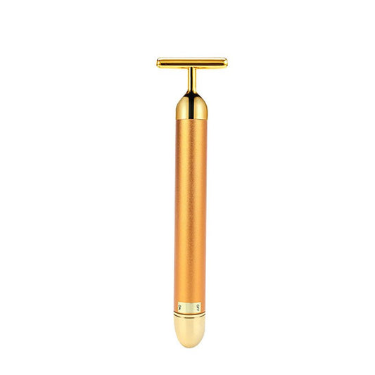 Gold-toned handheld device on a white background