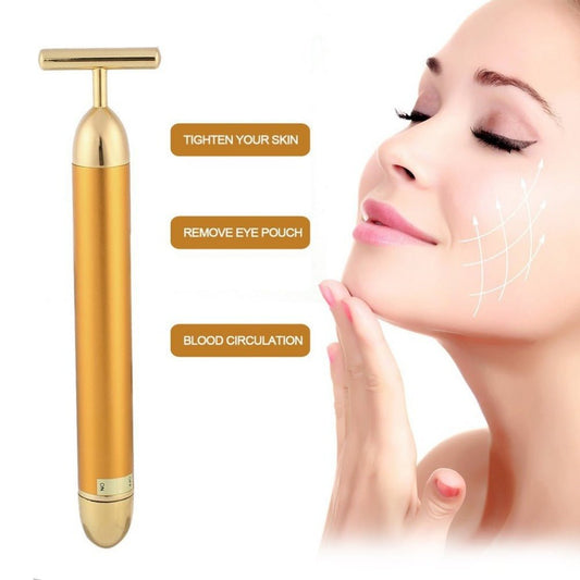 Gold facial massager with benefits on a white background