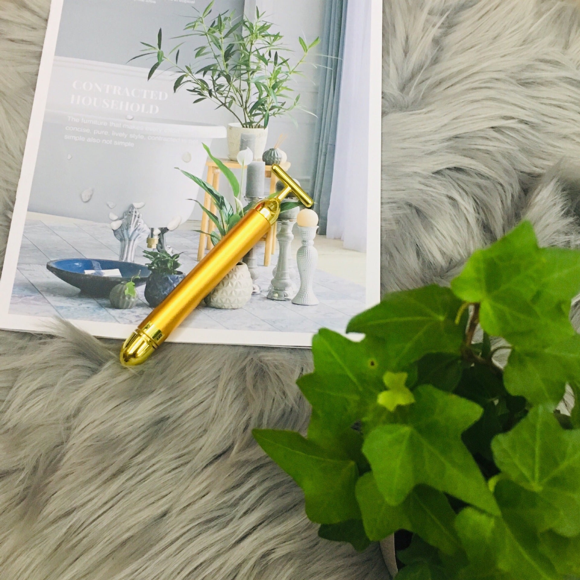 Gold roller on a textured surface with plants in the background