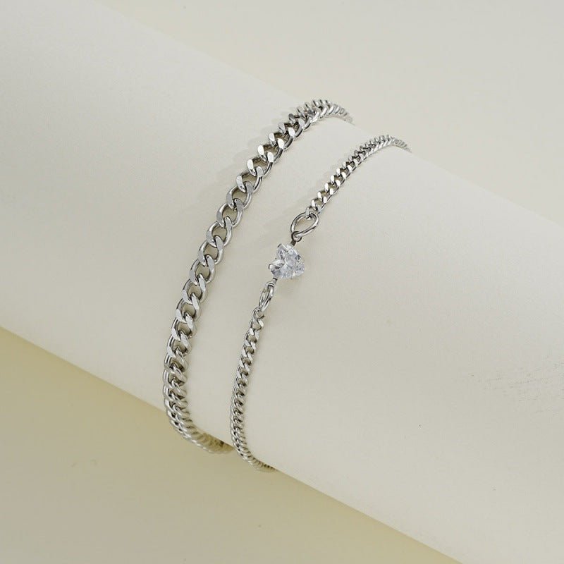 Silver chain bracelet with a star-shaped clasp on a light beige background