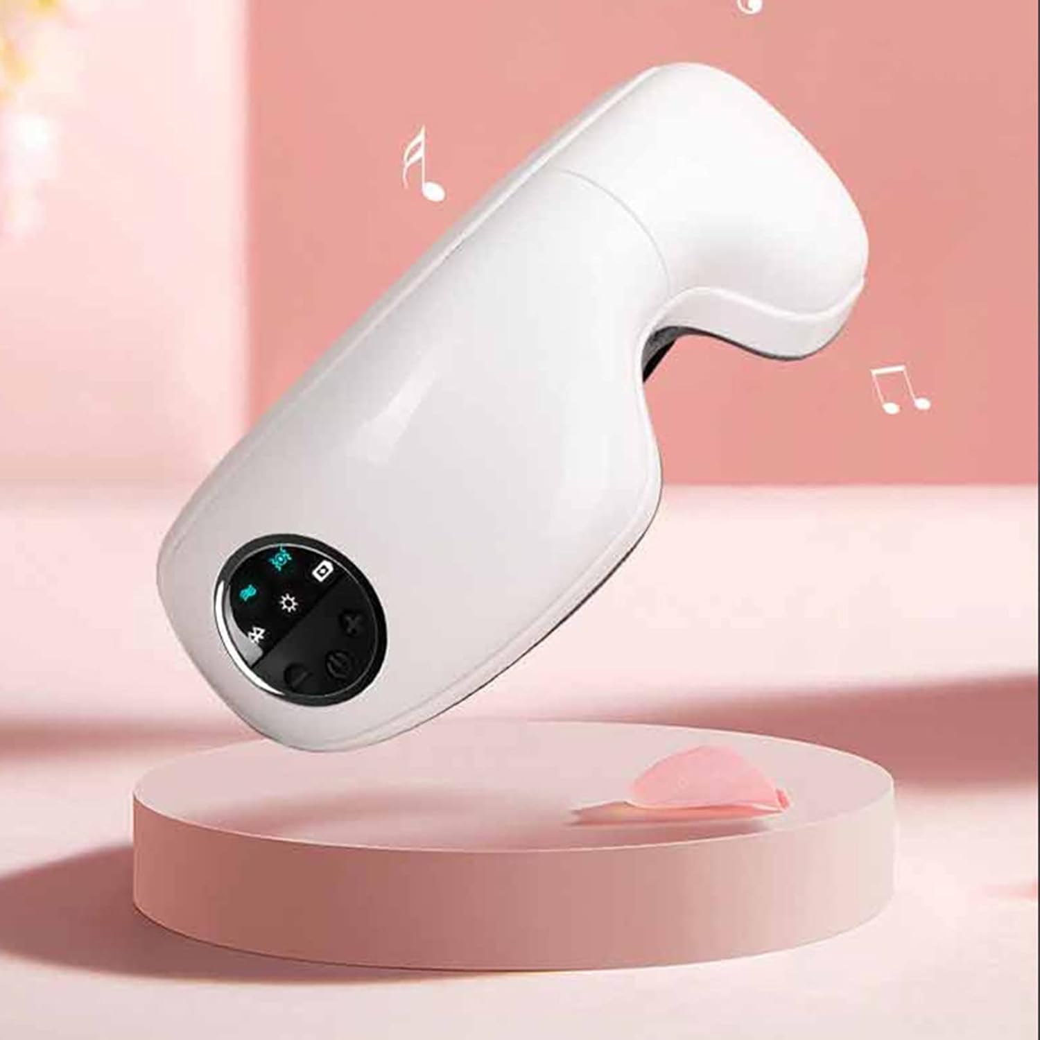 White eye massager with control panel on a pink platform and background
