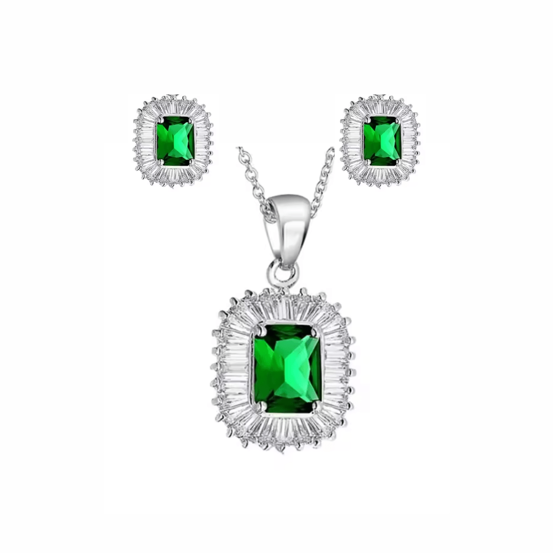 Jewelry set with pendant and earrings featuring green gemstones on a white background