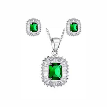 Jewelry set with pendant and earrings featuring green gemstones on a white background