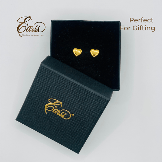 Heart-shaped gold earrings in a black box with 'Eauss' branding on a light gray background.