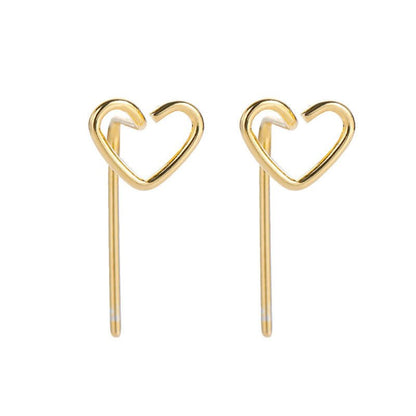 Gold heart-shaped earrings on a white background
