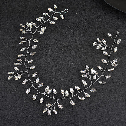Silver leaf-shaped jewelry piece on a black background