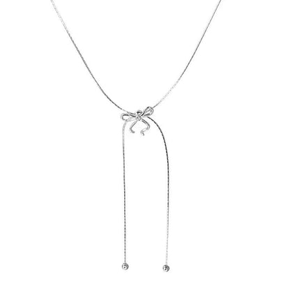 Silver necklace with a bow pendant on a white background