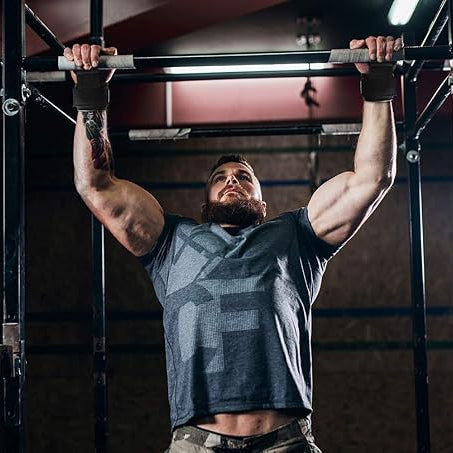 Man performing pull-ups in a gym setting