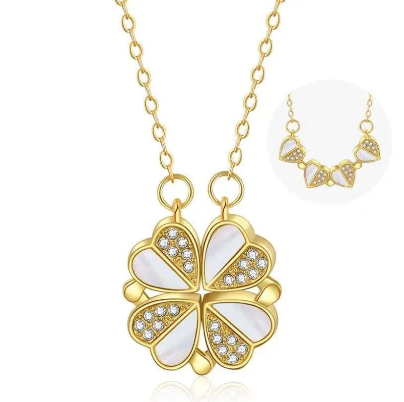Gold necklace with a four-leaf clover pendant on a white background