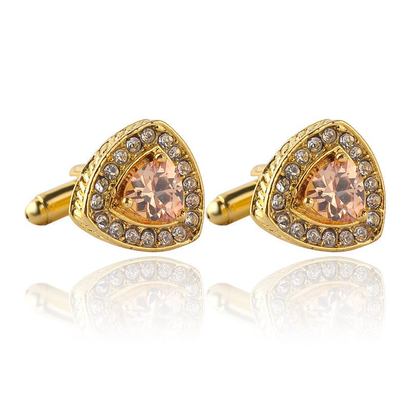 Gold cufflinks with peach-colored gemstones on a white background