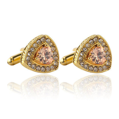 Gold cufflinks with peach-colored gemstones on a white background