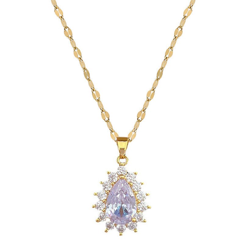 Gold necklace with a purple teardrop pendant on a white background