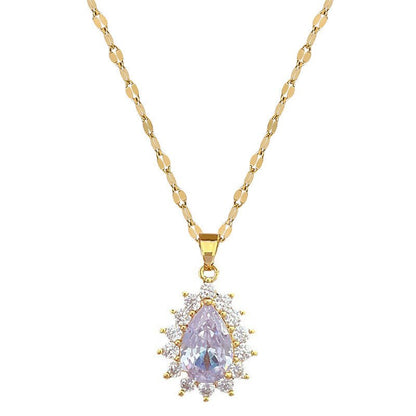 Gold necklace with a purple teardrop pendant on a white background