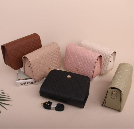 Collection of quilted mini handbags in various colors on a light pink background