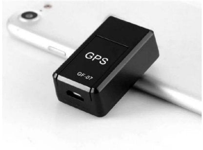 Black GPS tracker labeled GF-07 attached to a smartphone on a white background
