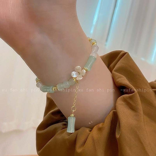 Beaded bracelet on a wrist with a neutral background