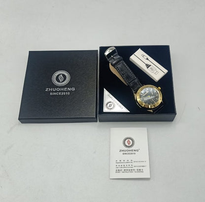Watch with black leather strap and gold case in a 'Zhuoheng' branded box on a light gray background.