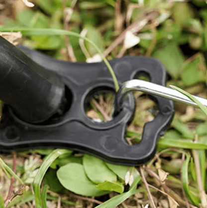 Black metal clip or hook on grass