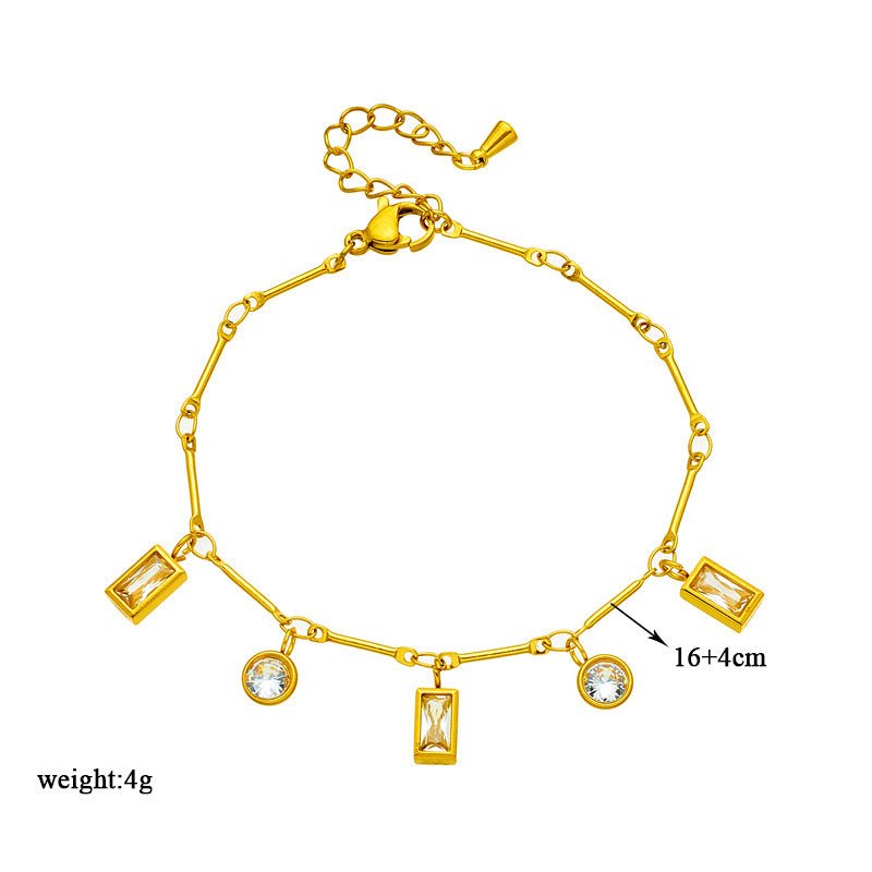 Gold bracelet with various charms on a white background